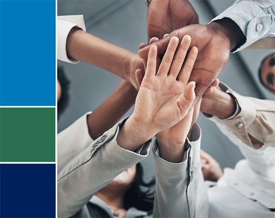 Image of hands stacked on top of one another - teamwork