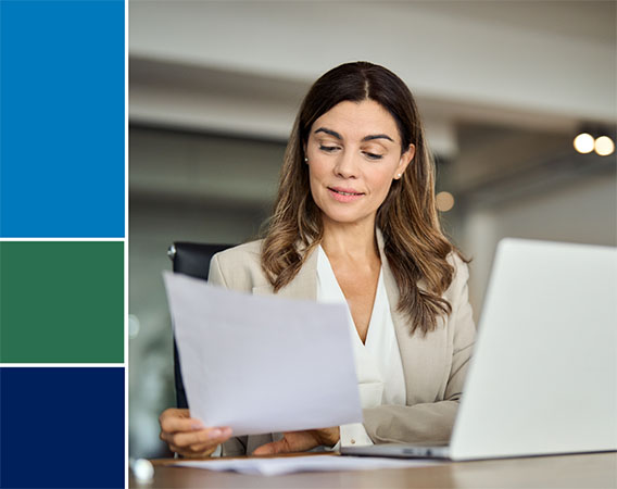 Woman sitting at desk reviewing paperwork