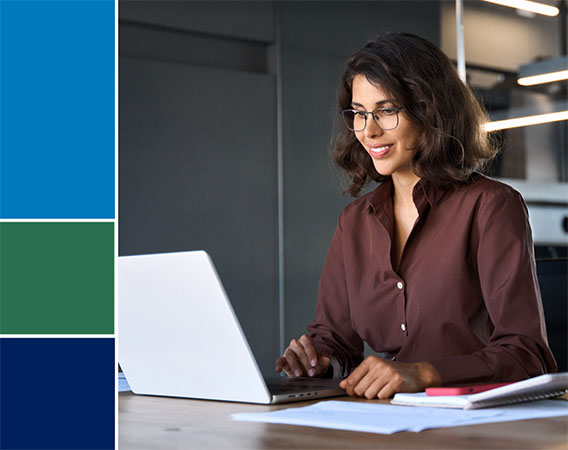 Woman at desk looking at laptop