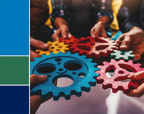 Image of five people holding gears that connect to one another, focus on connected gears