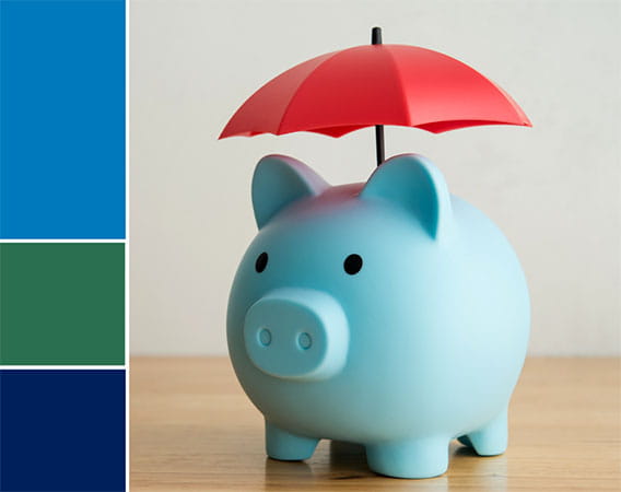 Blue piggy bank with red umbrella over it