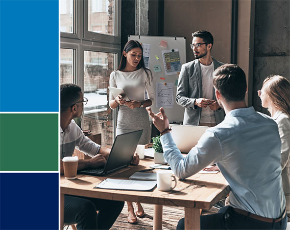 Group of five people at a table in discussion